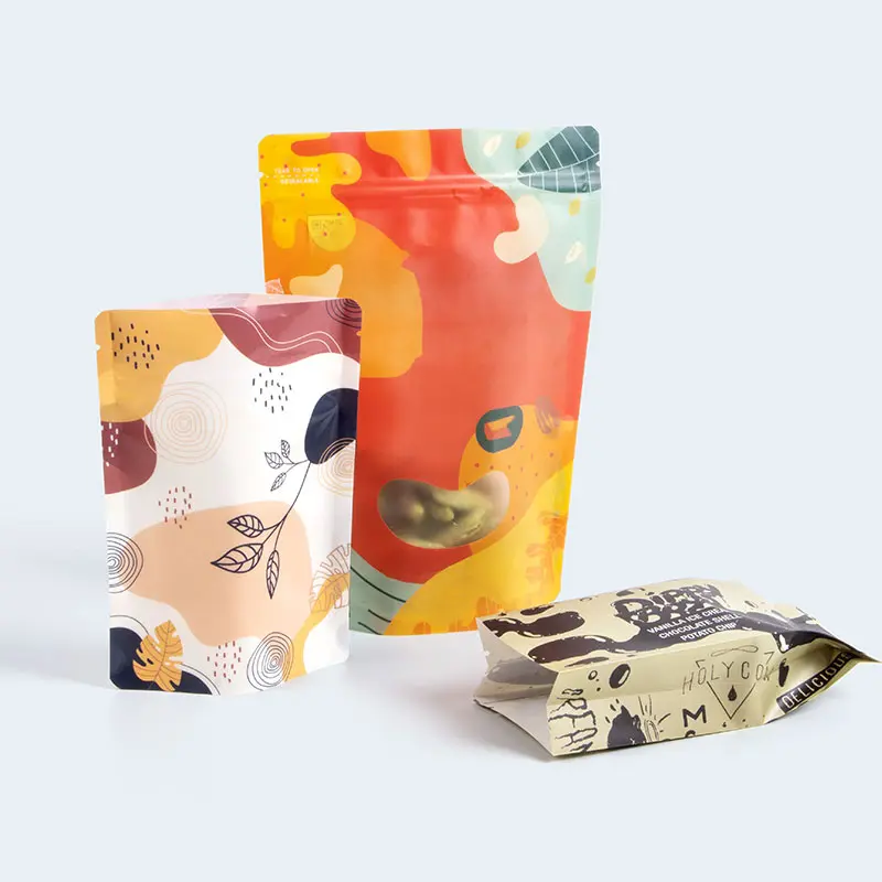 Three colorful, patterned pouches are displayed against a light gray background. The designs feature abstract and nature-inspired illustrations, including leaves and whimsical shapes in various colors like orange, yellow, red, and blue. Perfect for adding a touch of artful organization to your home, one pouch lies flat while the other two stand upright.