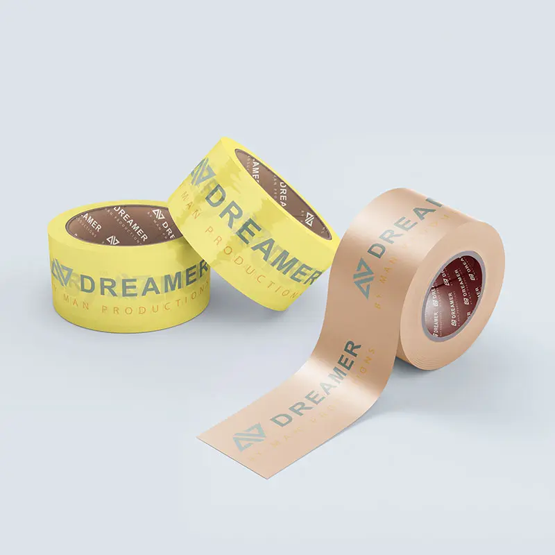 Two rolls of yellow adhesive tape and one roll of beige adhesive tape are arranged with one beige strip partially unrolled. The tape, perfect for home projects, is branded with the text "DREAMER" along with other smaller text and design elements. All items are on a light background.