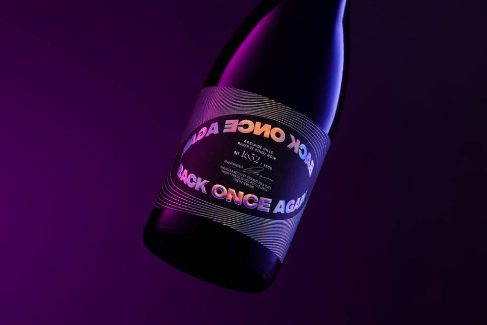 Back Once Again: Recycled Wine Labels with a Holographic Edge